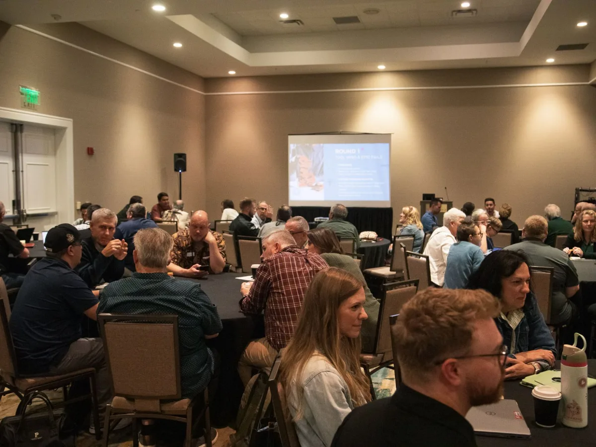 Mission leaders talking in small groups around tables at a Missio Nexus gathering