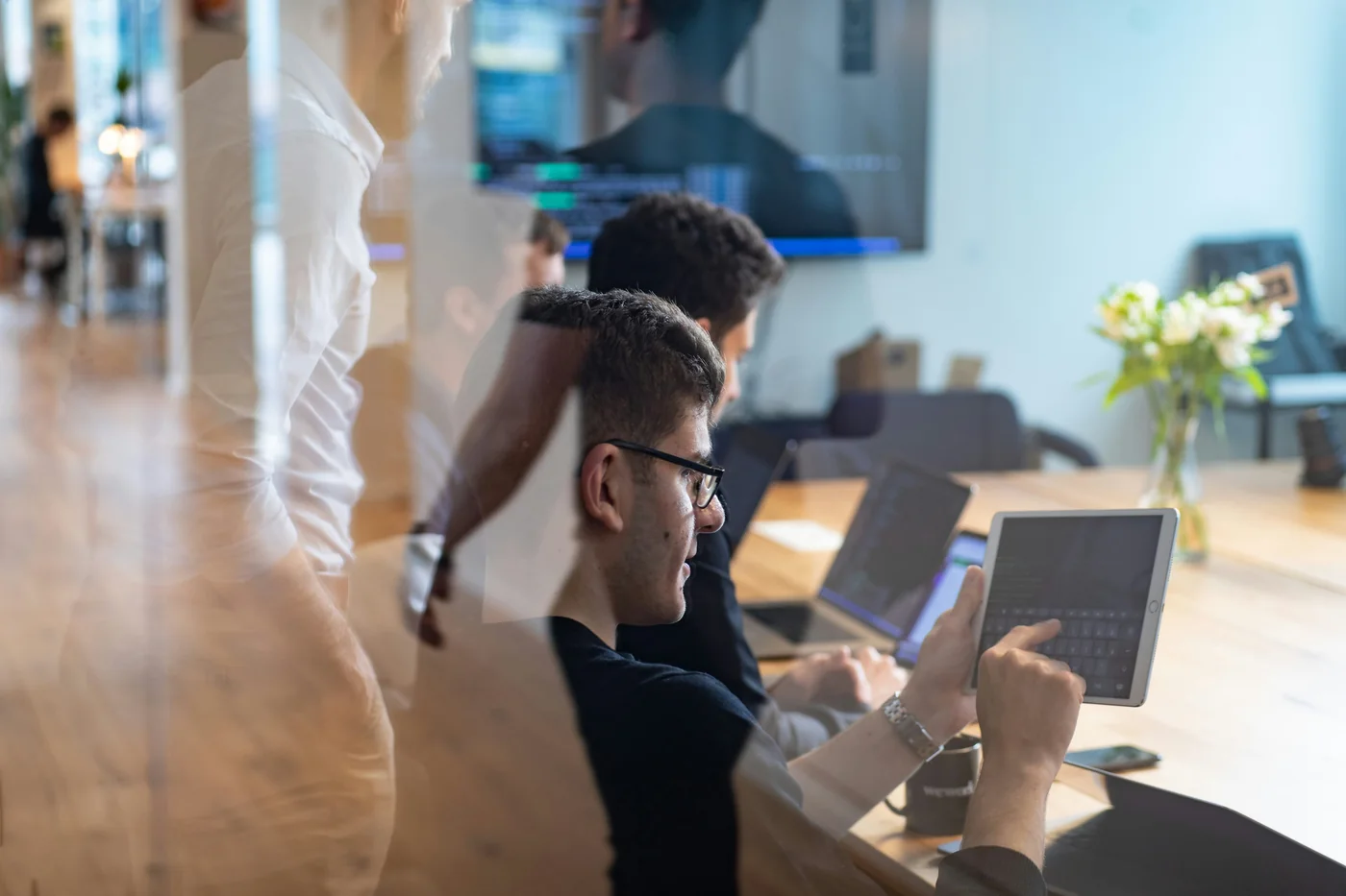 Members working together at laptops in a shared workspace