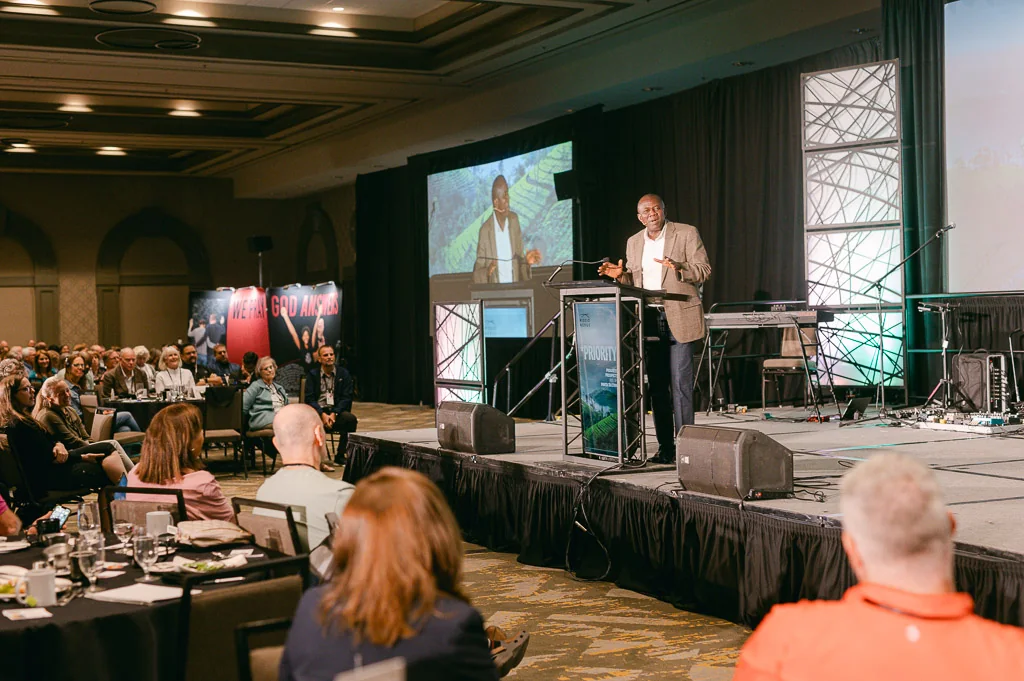 A speaker addressing the Mission Leaders Conference from the main stage