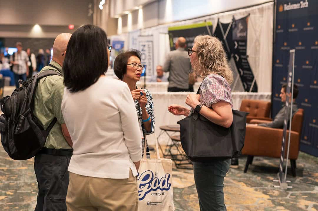 Attendees talking in the exhibit hall