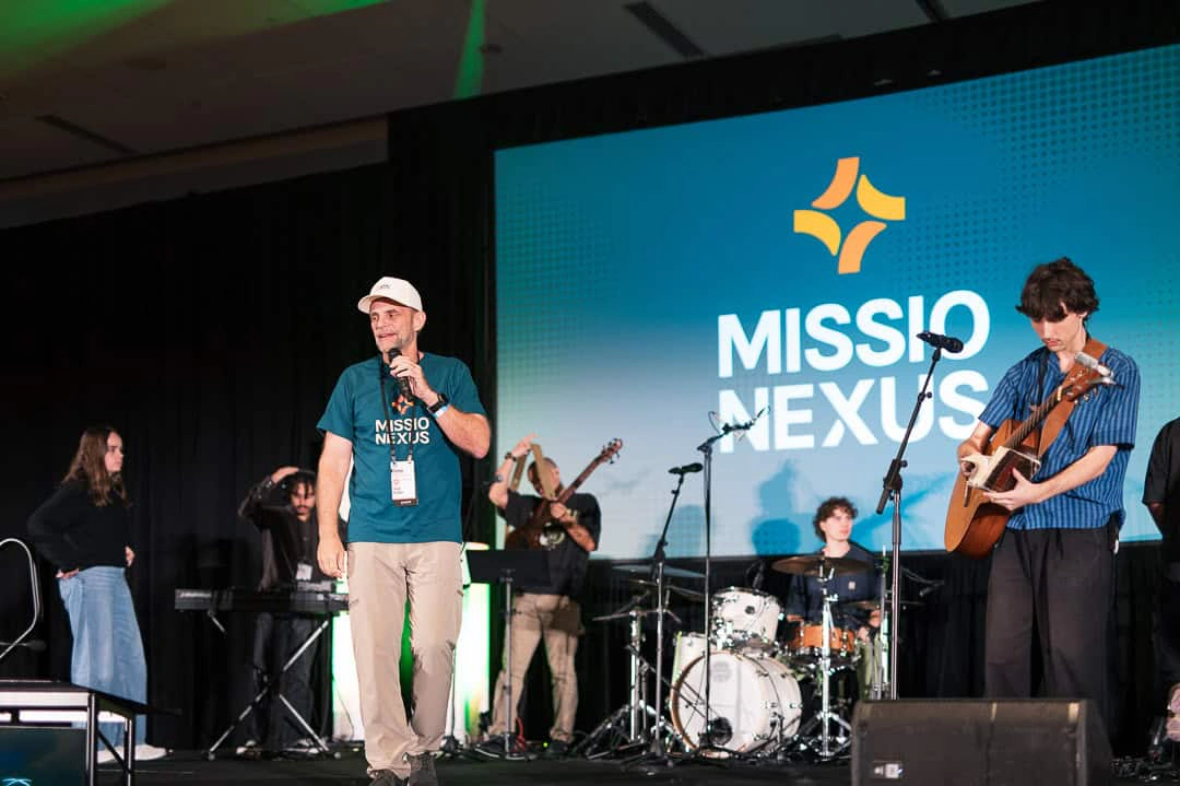 The new Missio Nexus logo on the main-stage screen with the band below