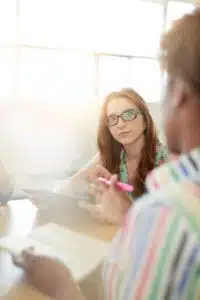 Unposed group of creative business people in an open concept office brainstorming their next project.