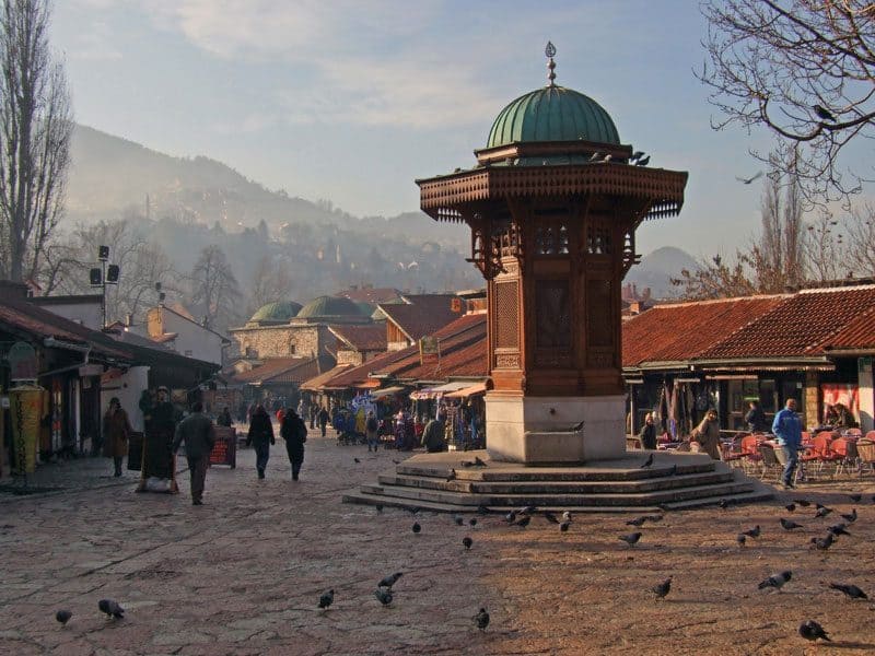 Bustling outdoor market with vendors and shoppers in Nepal.