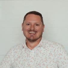 Man smiling at Missio Nexus event in Cincinnati, engaging in faith-based networking.