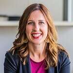 Woman smiling at Missio Nexus event, representing mission organization.