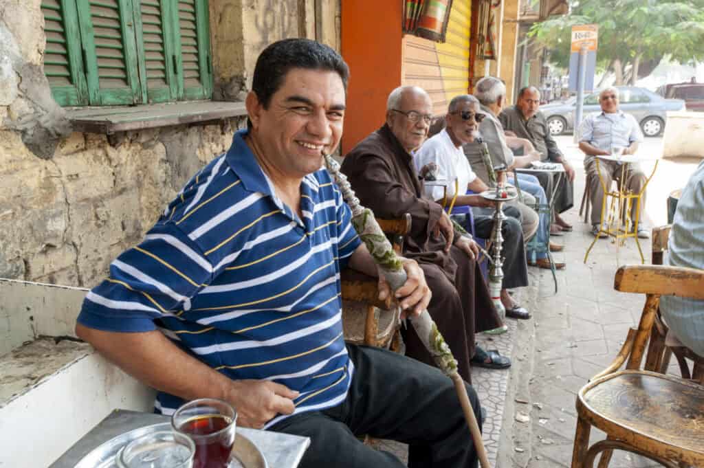Group of men enjoying tea outdoors, highlighting healing and community in missions.