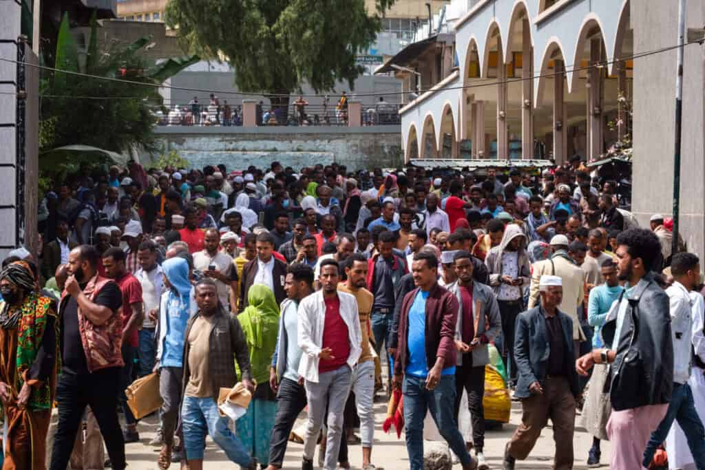 Crowd of people in an urban setting, emphasizing community and resilience.