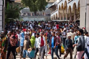 Crowd of people in an urban setting, emphasizing community and resilience.