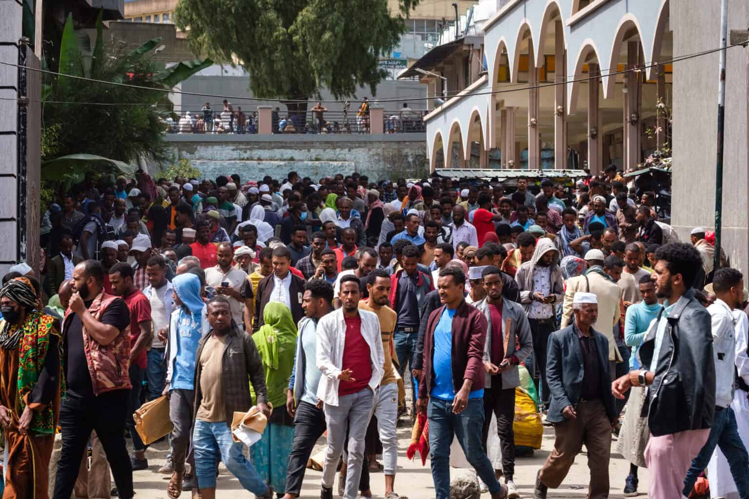 Crowd of people in an urban setting, emphasizing community and resilience.