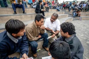 Missionaries and community members having a discussion on steps of an outdoor amphitheater.