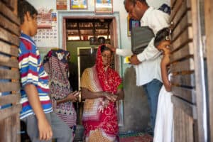 Community members engaged in holistic ministry activities in a rural setting.