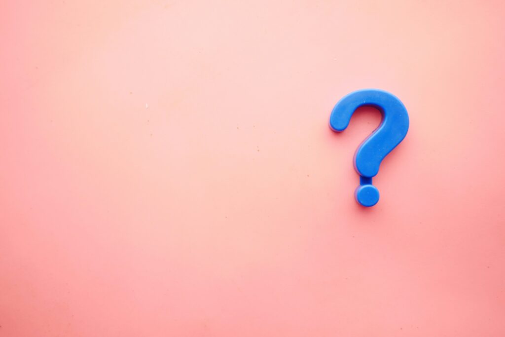 Clear blue question mark on pink background representing inquiry or support.