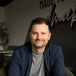 Portrait of a smiling man in a casual setting at Missio Nexus.